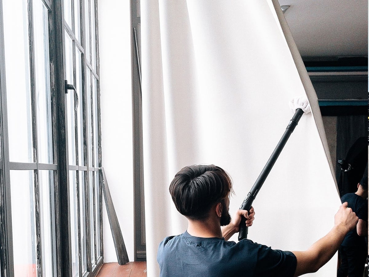 Aclean Steamers technician performing professional curtain cleaning in a Charlotte, NC home