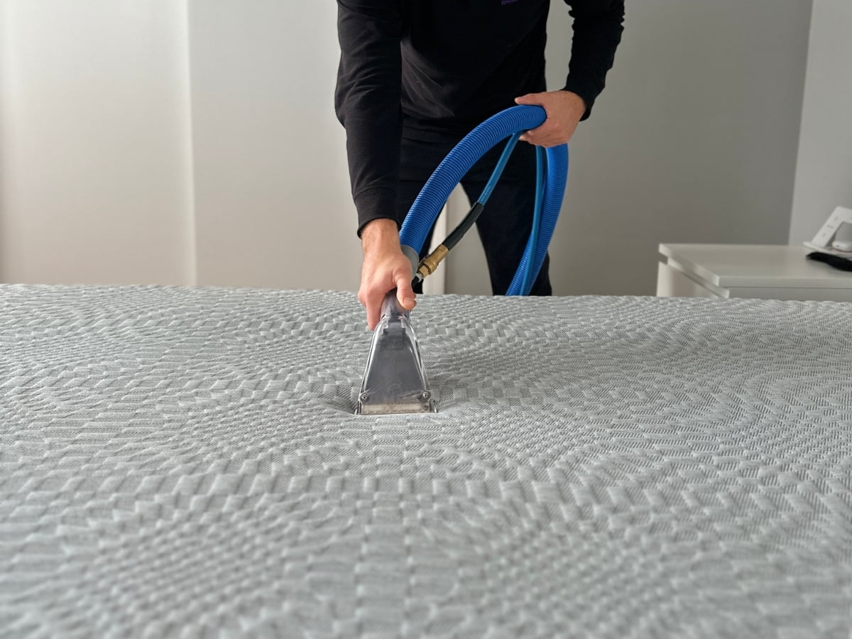 Aclean Steamers technician performing professional mattress cleaning in a Charlotte, NC home