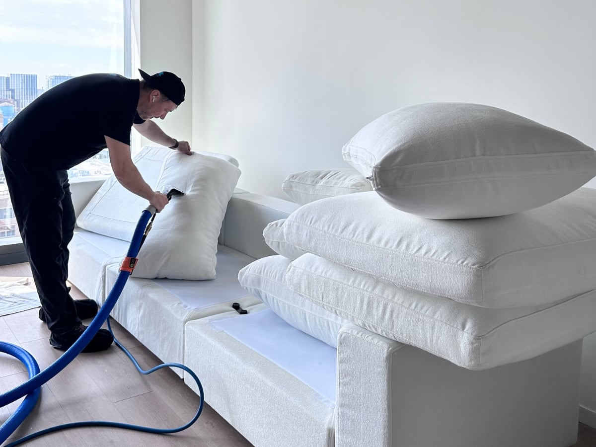 Aclean Steamers technician performing professional upholstery cleaning in a Charlotte, NC home
