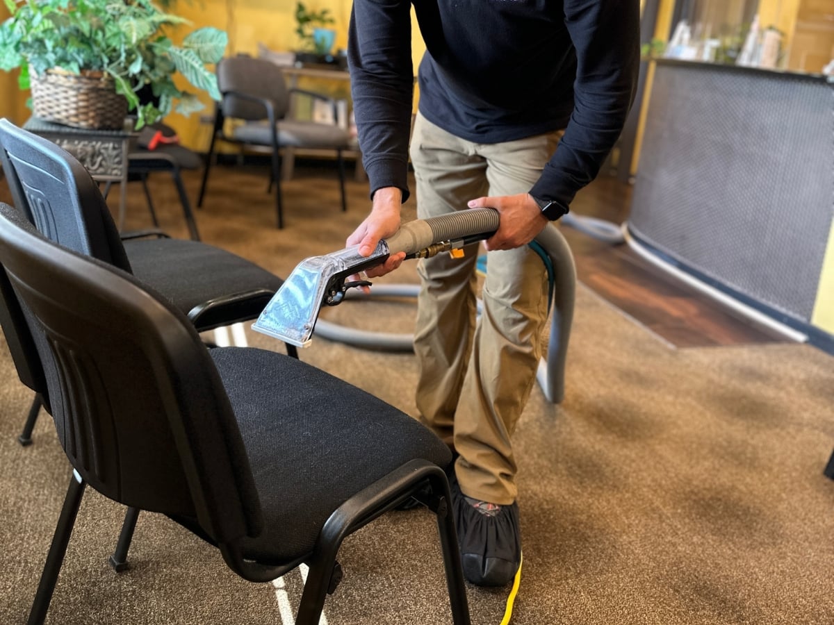 Aclean Steamers technician performing professional chair cleaning in a Raleigh, NC home