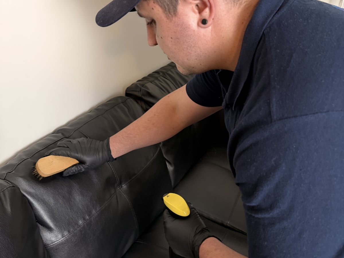 Aclean Steamers technician performing professional leather cleaning in a Raleigh, NC home