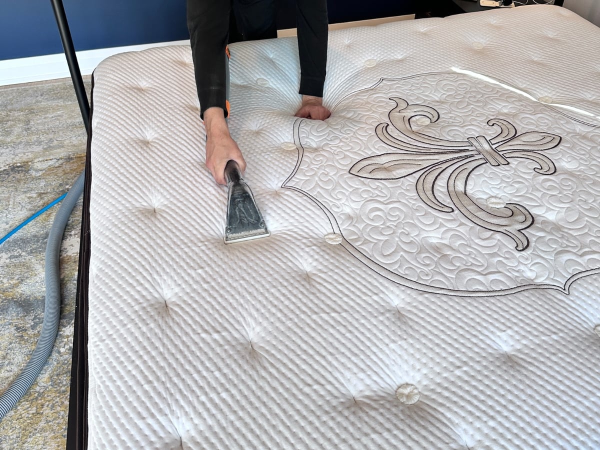 Aclean Steamers technician performing professional mattress cleaning in a Raleigh, NC home