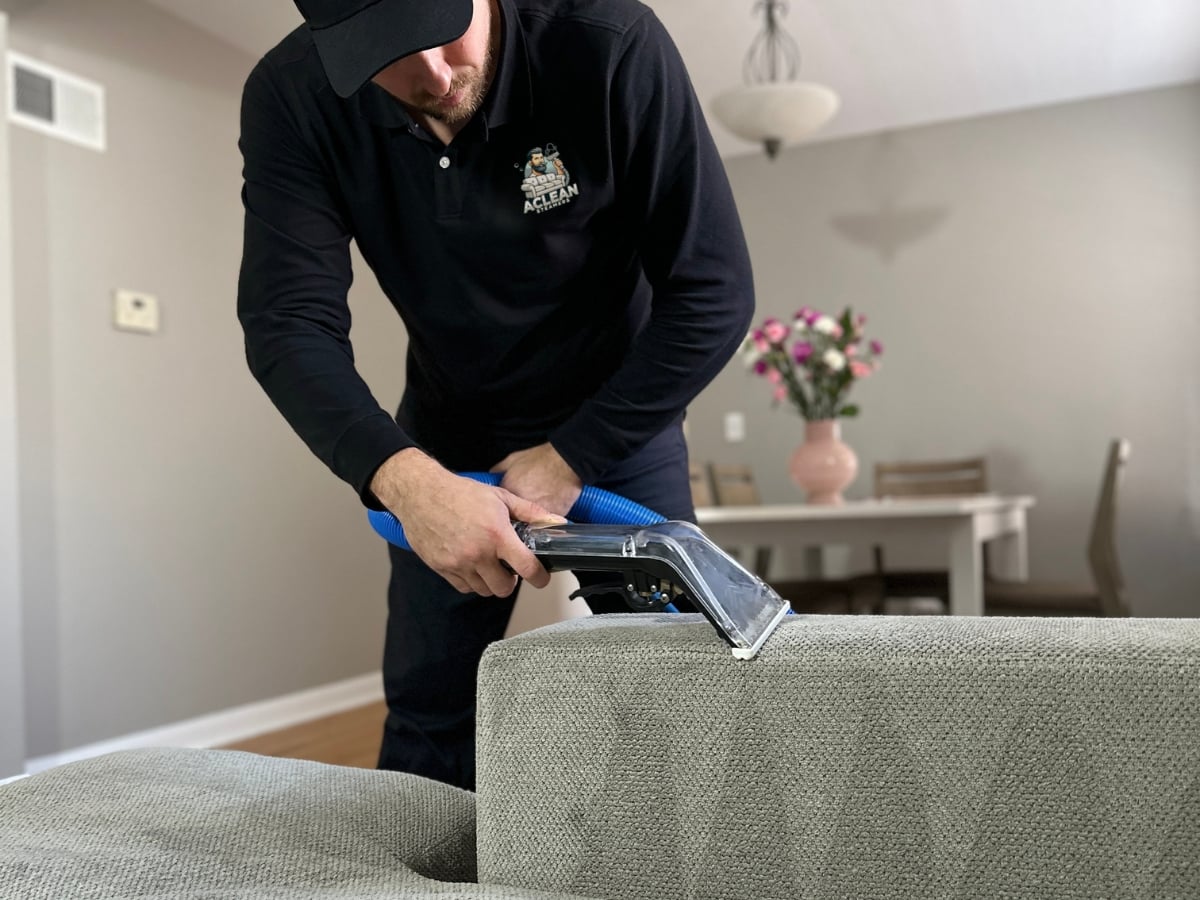 Aclean Steamers technician performing professional upholstery cleaning in a Raleigh, NC home
