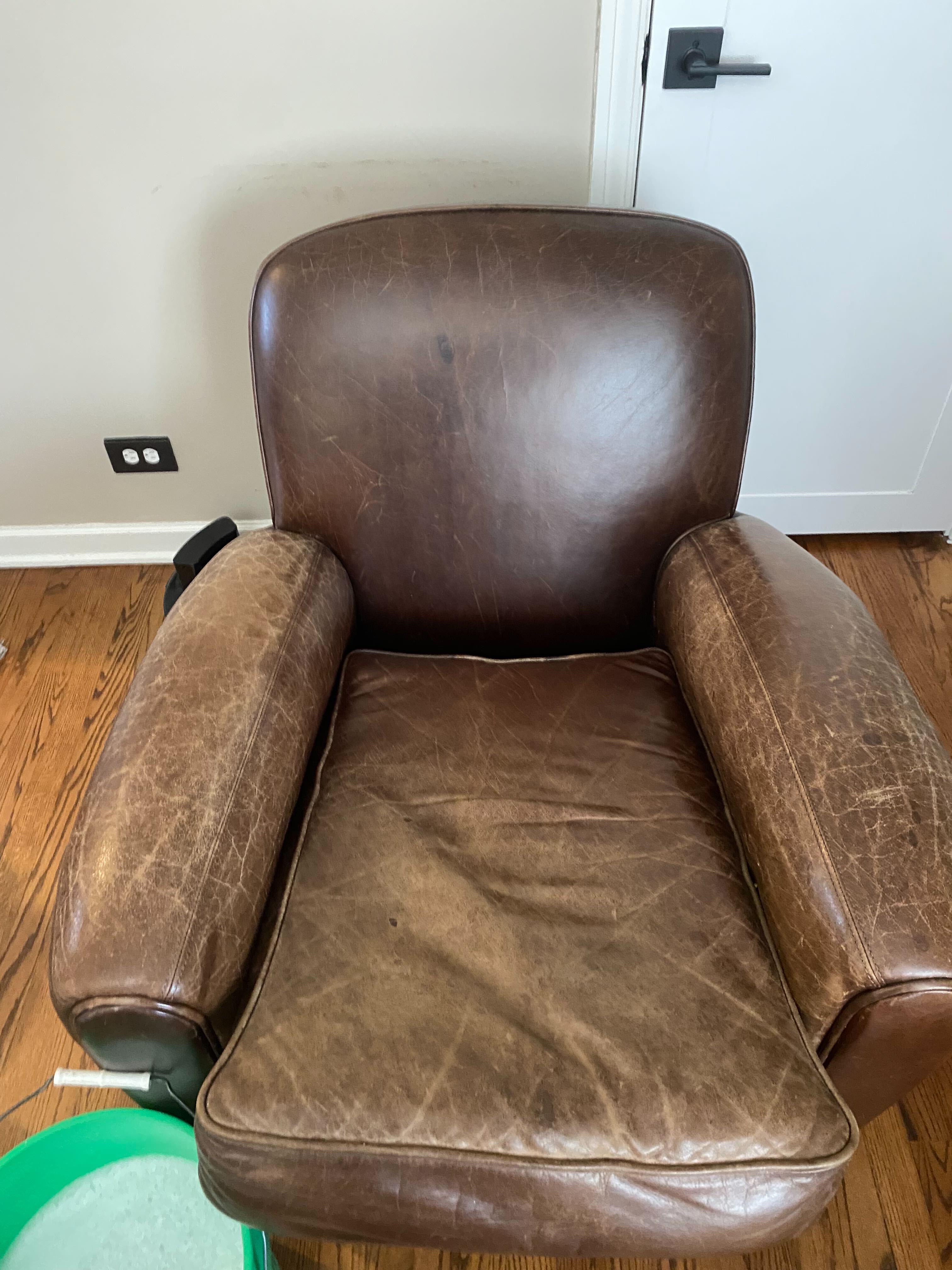 Worn leather sofa in a Charlotte home before professional cleaning and conditioning