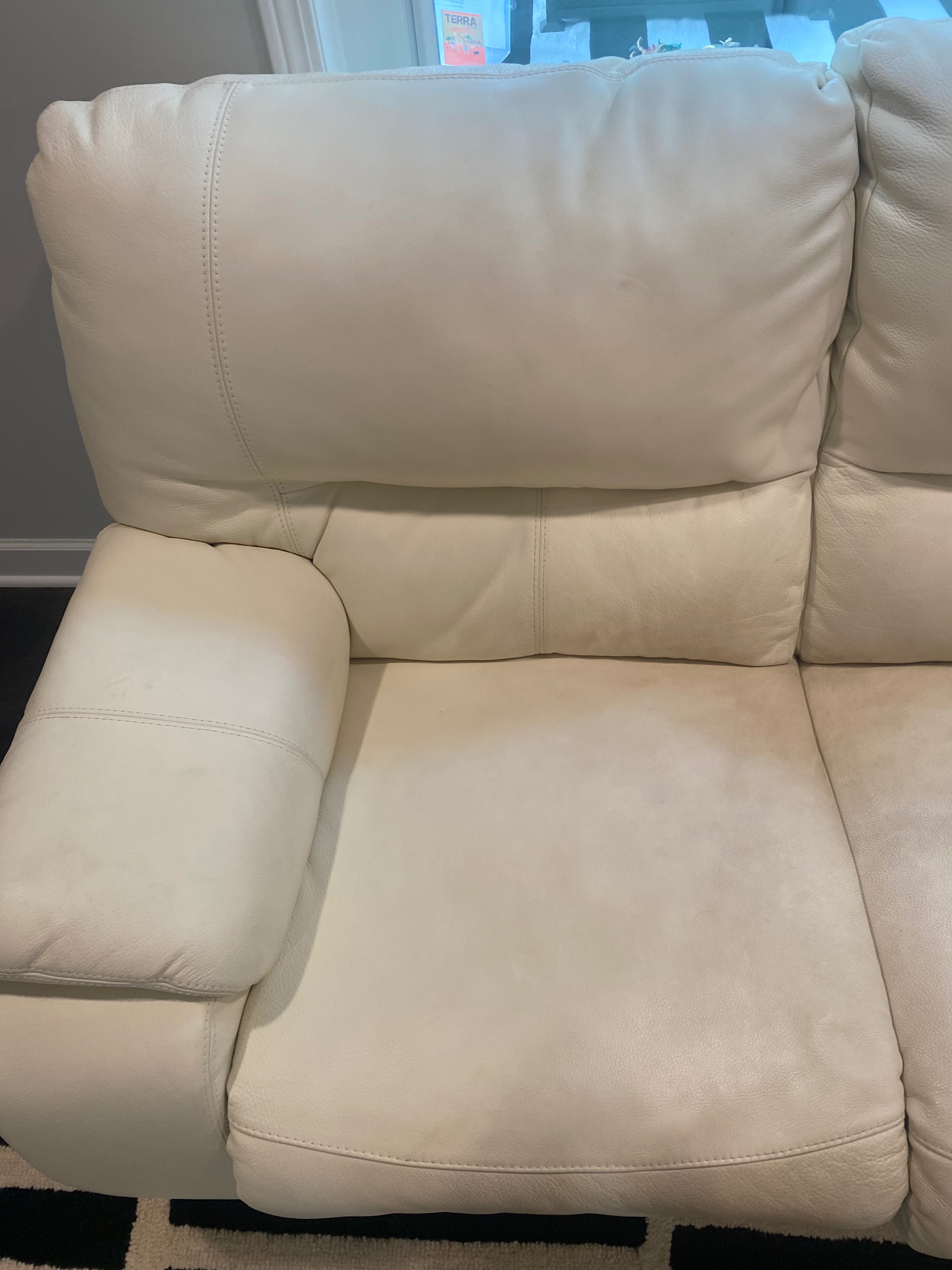 Stained leather chair in a Charlotte home before professional leather cleaning